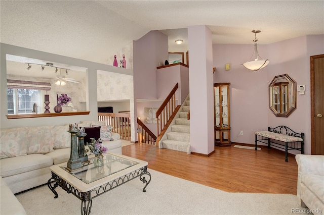 living room featuring lofted ceiling, ceiling fan, and hardwood / wood-style floors