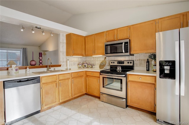 kitchen with vaulted ceiling, stainless steel appliances, decorative backsplash, and sink