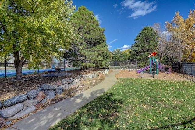 view of yard with tennis court and a playground