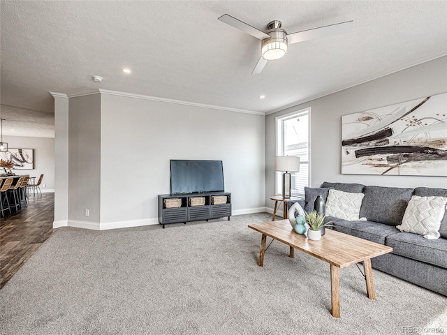 carpeted living room featuring a textured ceiling, ceiling fan, and crown molding