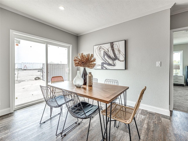 dining room with a textured ceiling, hardwood / wood-style flooring, and crown molding