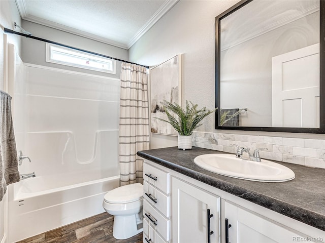 full bathroom with hardwood / wood-style floors, shower / bath combination with curtain, toilet, vanity, and a textured ceiling