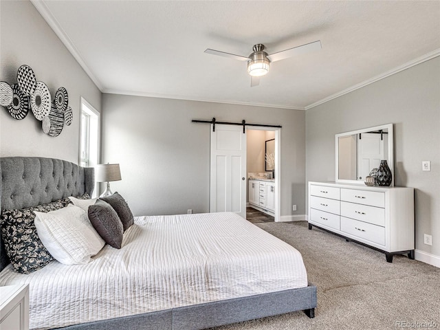 carpeted bedroom featuring ceiling fan, a barn door, crown molding, and connected bathroom