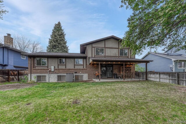 17390 E Greenwood Cir, Aurora, CO 80013 - rear view of house with brick siding, central air condition unit, and a patio area