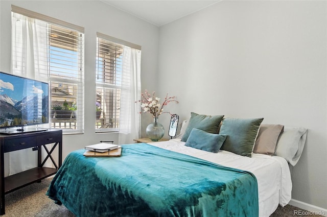 carpeted bedroom featuring baseboards