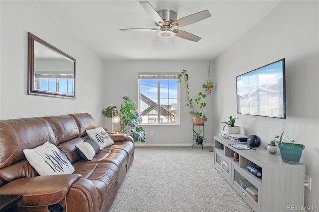 carpeted living area featuring baseboards and ceiling fan