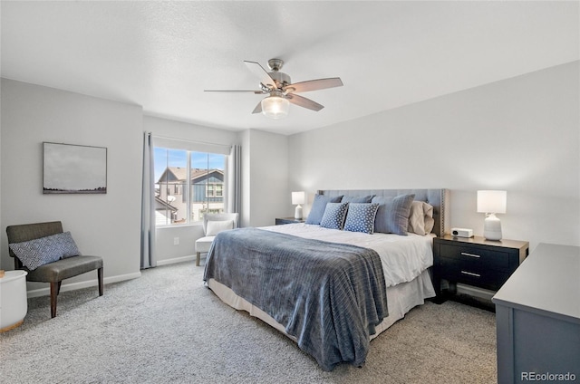 bedroom featuring baseboards, a ceiling fan, and light colored carpet