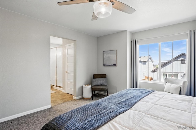 carpeted bedroom with baseboards and a ceiling fan