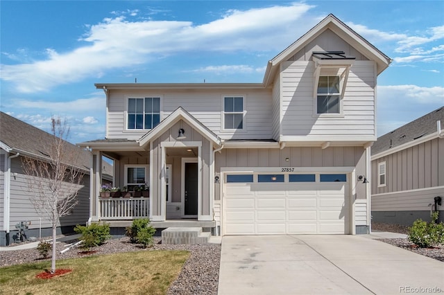traditional-style house featuring a porch, a garage, board and batten siding, and driveway