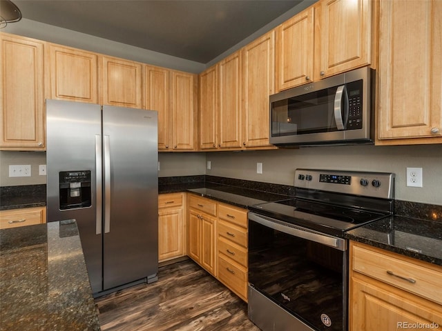 kitchen with dark stone countertops, dark hardwood / wood-style flooring, light brown cabinets, and appliances with stainless steel finishes