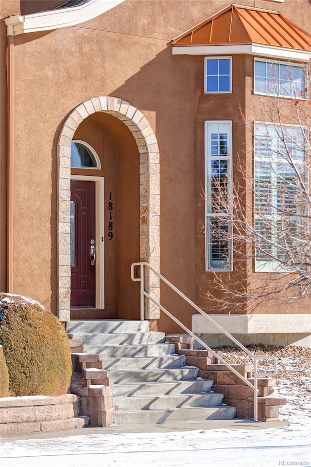 view of snow covered property entrance