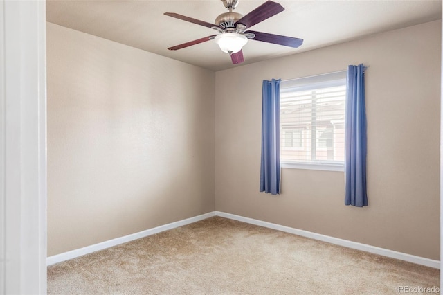 carpeted spare room featuring ceiling fan