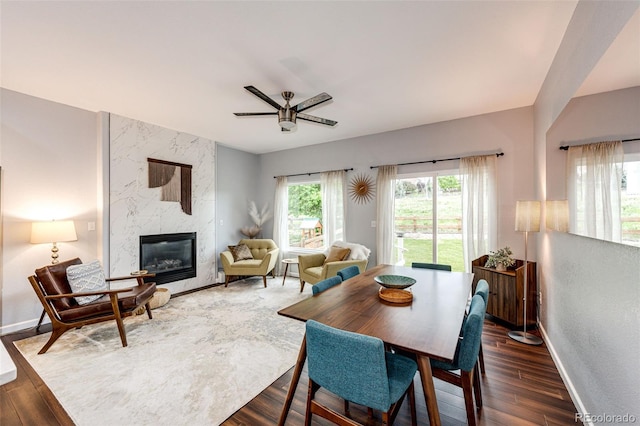 22026 Hill Gail Way, Parker, CO 80138 - dining space with a ceiling fan, a high end fireplace, baseboards, and dark wood finished floors