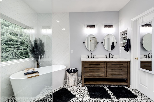 22026 Hill Gail Way, Parker, CO 80138 - bathroom featuring a freestanding tub, double vanity, tile walls, and tile patterned floors