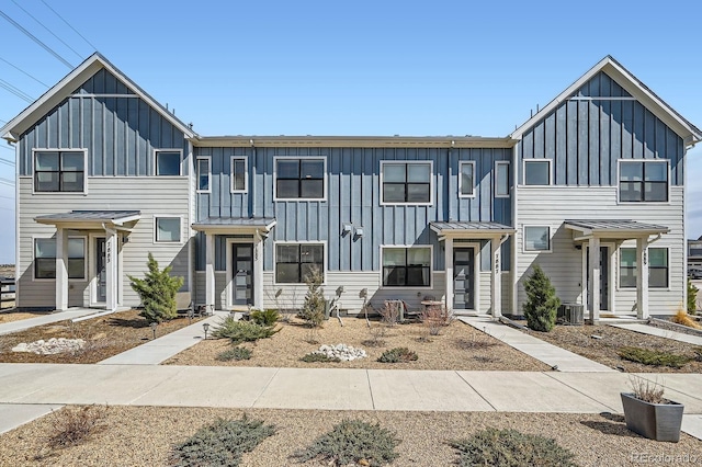 townhome / multi-family property featuring cooling unit and board and batten siding