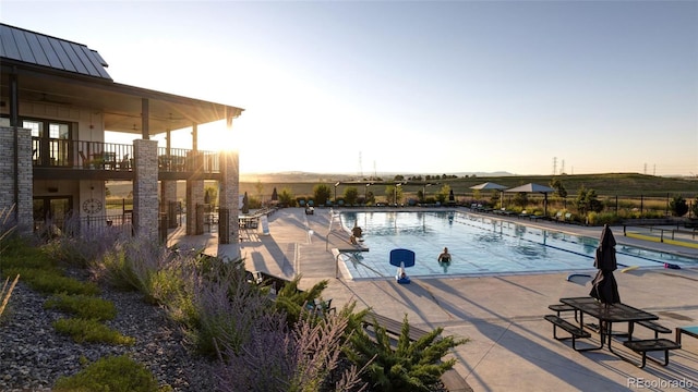 pool featuring a patio area and fence