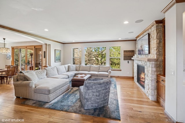 living room featuring a fireplace, a healthy amount of sunlight, and ornamental molding
