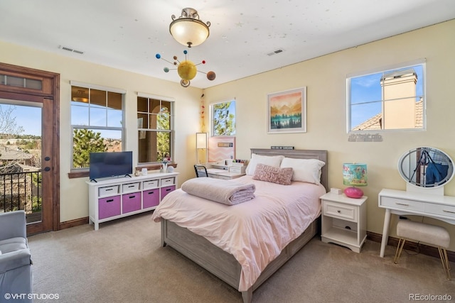 carpeted bedroom featuring access to exterior, baseboards, and multiple windows