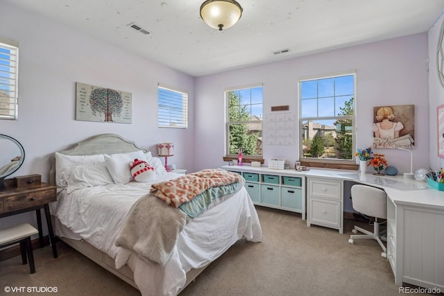 bedroom with visible vents and light colored carpet