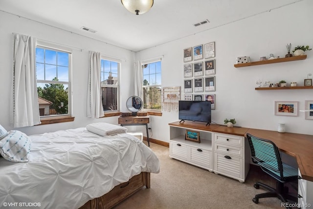 bedroom with visible vents and light colored carpet