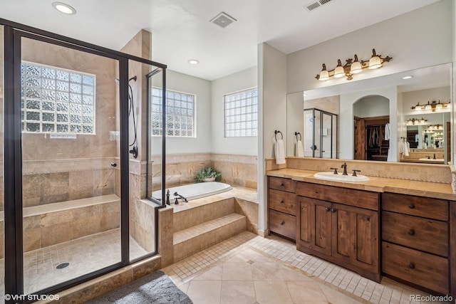 full bathroom with a bath, tile patterned floors, visible vents, a shower stall, and vanity