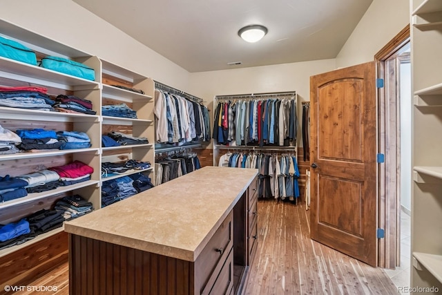 walk in closet featuring light wood-style flooring and visible vents