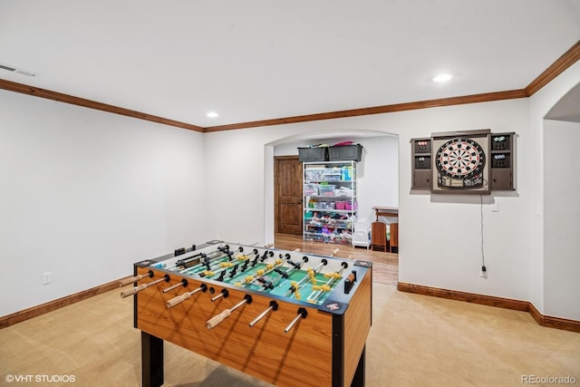 rec room with baseboards, carpet flooring, and arched walkways