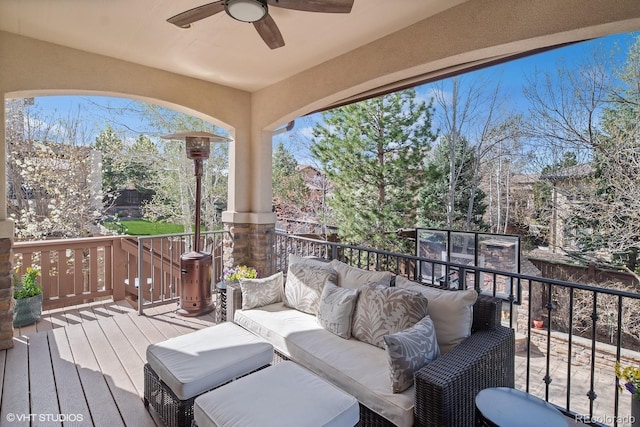 wooden deck with ceiling fan and an outdoor hangout area