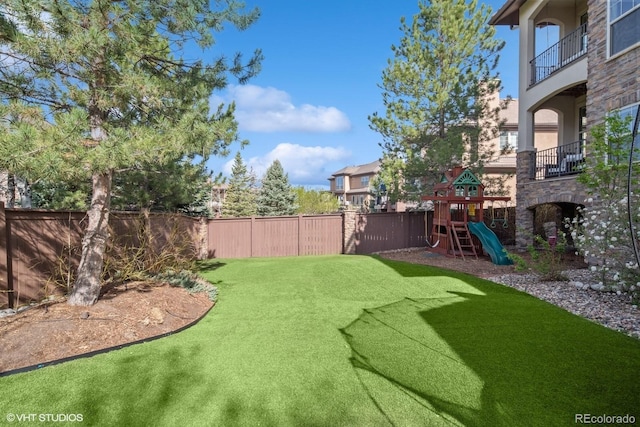 view of yard with a fenced backyard and a playground