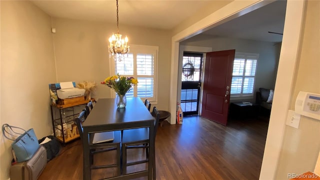 dining space featuring a chandelier and dark wood finished floors