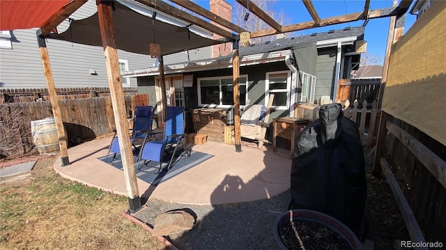 view of patio with fence and a pergola