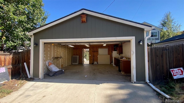 detached garage featuring fence