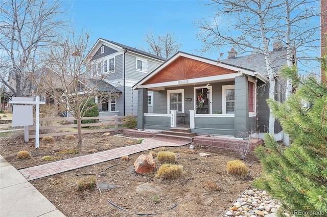 2033 S Ogden St, Denver, CO 80210 - view of front of house with a porch and a chimney