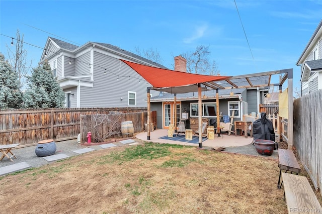 2033 S Ogden St, Denver, CO 80210 - rear view of property with a patio, a chimney, and a fenced backyard