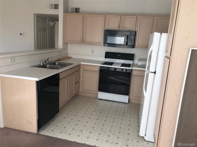 kitchen featuring light brown cabinets, a sink, visible vents, light countertops, and black appliances