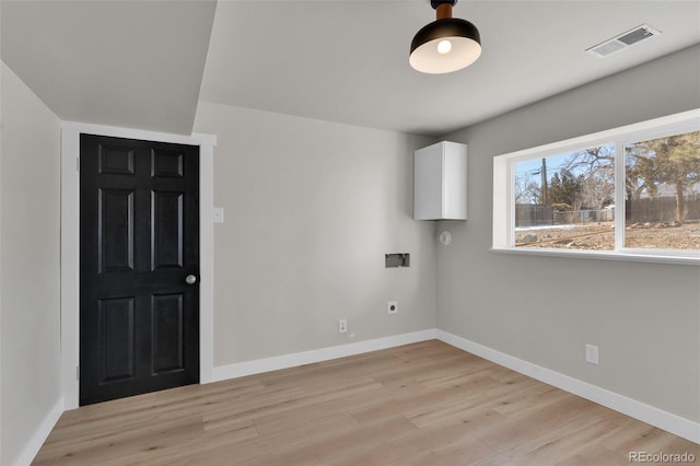 clothes washing area with hookup for a washing machine, light hardwood / wood-style floors, and electric dryer hookup