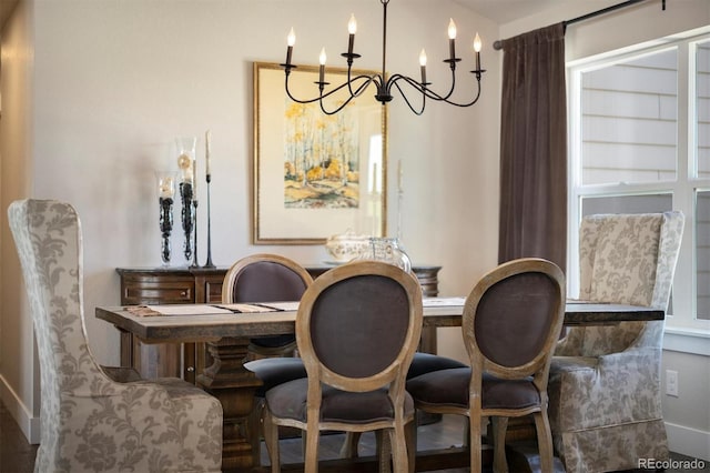 dining space with a chandelier and baseboards