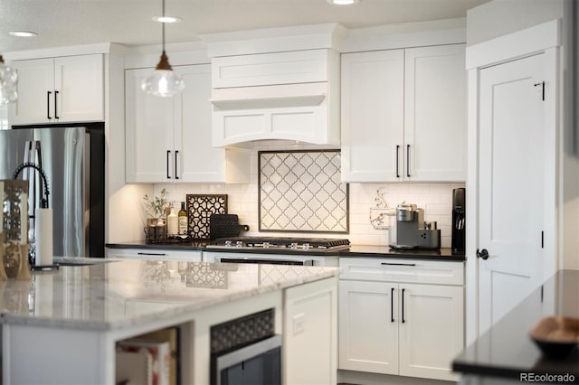 kitchen with stainless steel appliances, white cabinets, tasteful backsplash, recessed lighting, and light stone countertops
