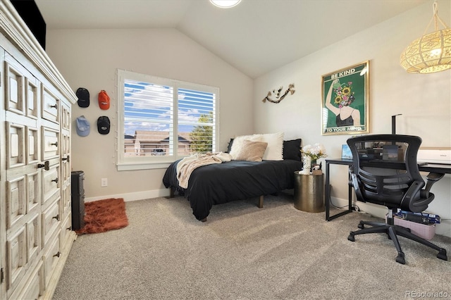 carpeted bedroom with vaulted ceiling and baseboards