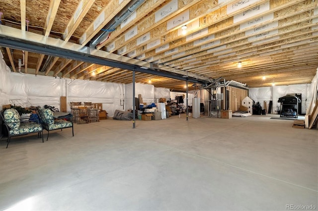 unfinished below grade area featuring water heater
