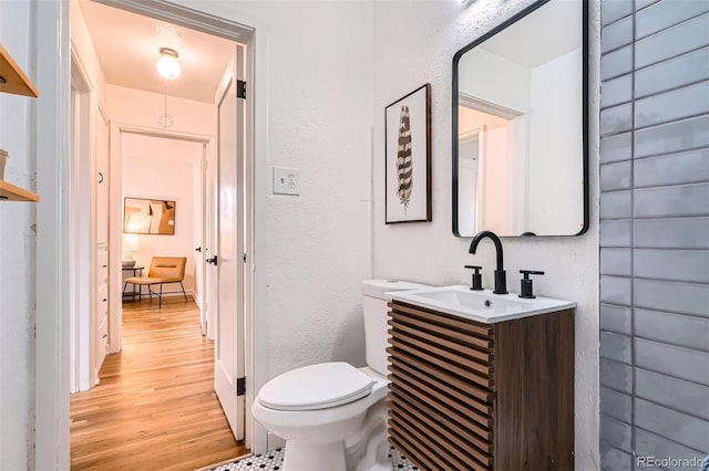 bathroom featuring hardwood / wood-style floors, vanity, and toilet