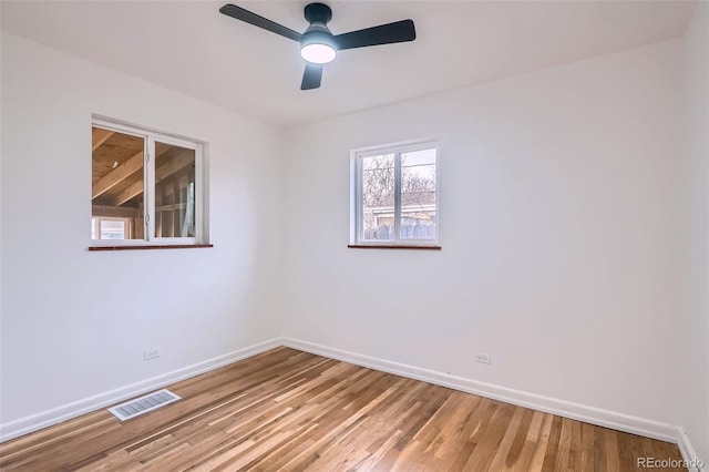 spare room featuring hardwood / wood-style floors and ceiling fan