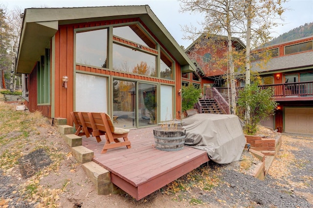 2720 S Spring Gulch Rd, Idaho Springs, CO 80452 - rear view of property with an outdoor fire pit, board and batten siding, a wooden deck, and stairway