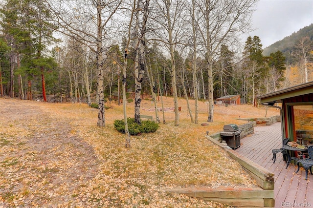 2720 S Spring Gulch Rd, Idaho Springs, CO 80452 - view of yard with a wooden deck and a view of trees