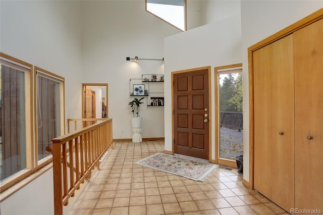 2720 S Spring Gulch Rd, Idaho Springs, CO 80452 - foyer featuring a high ceiling, light tile patterned floors, and baseboards