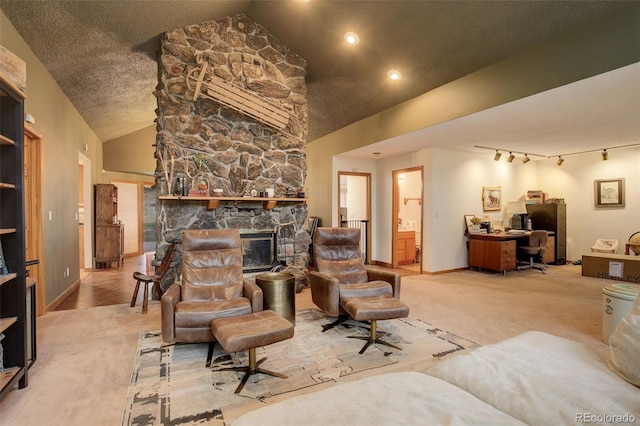 2720 S Spring Gulch Rd, Idaho Springs, CO 80452 - carpeted living area featuring an office area, vaulted ceiling, baseboards, and a stone fireplace