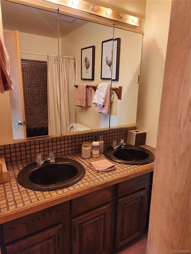 2720 S Spring Gulch Rd, Idaho Springs, CO 80452 - bathroom featuring double vanity and a shower with curtain