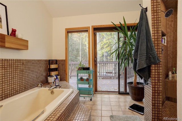2720 S Spring Gulch Rd, Idaho Springs, CO 80452 - bathroom with a garden tub, tile patterned flooring, and vaulted ceiling