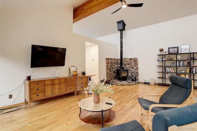 2720 S Spring Gulch Rd, Idaho Springs, CO 80452 - living area featuring a wood stove, ceiling fan, and wood finished floors