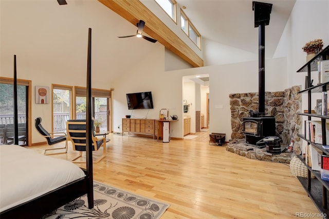 2720 S Spring Gulch Rd, Idaho Springs, CO 80452 - bedroom featuring a wood stove, high vaulted ceiling, wood finished floors, beamed ceiling, and access to exterior